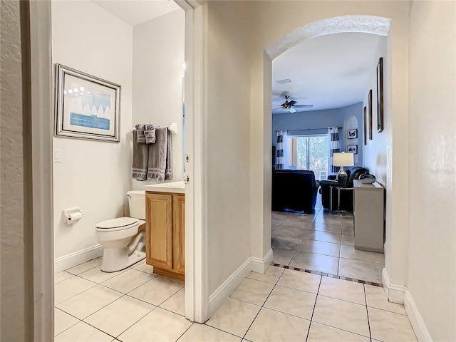 bathroom featuring vanity, tile floors, ceiling fan, and toilet