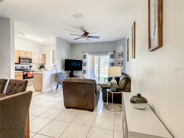 living room with light tile floors and ceiling fan