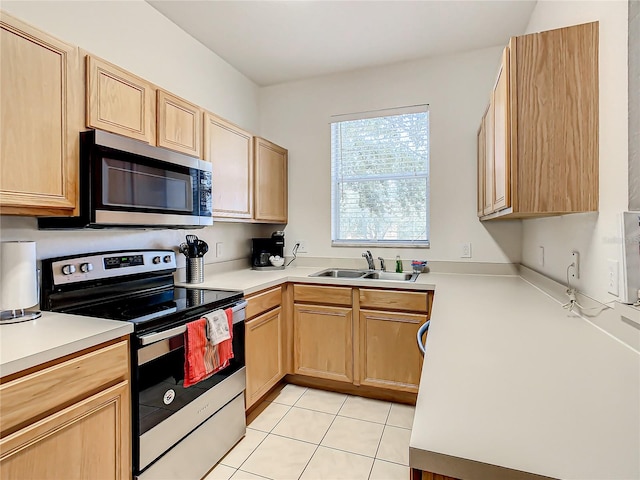 kitchen featuring light brown cabinets, appliances with stainless steel finishes, light tile floors, and sink