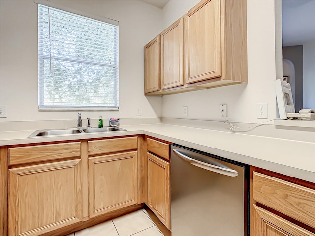 kitchen with a healthy amount of sunlight, stainless steel dishwasher, light tile floors, and sink