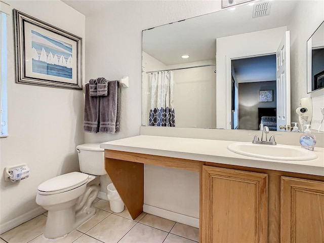 bathroom with toilet, tile flooring, and vanity