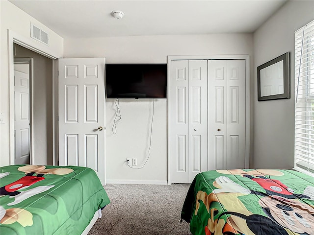 carpeted bedroom with a closet