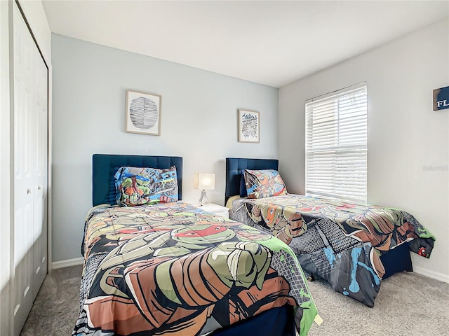 bedroom with a closet and light carpet