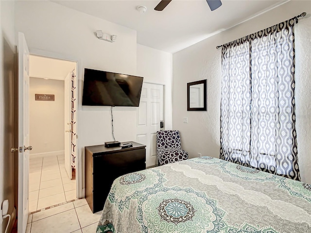 tiled bedroom with ceiling fan