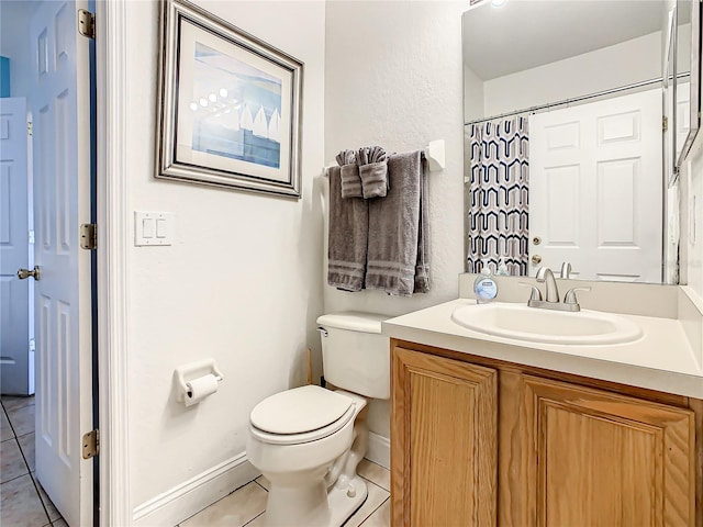 bathroom featuring vanity, tile floors, and toilet