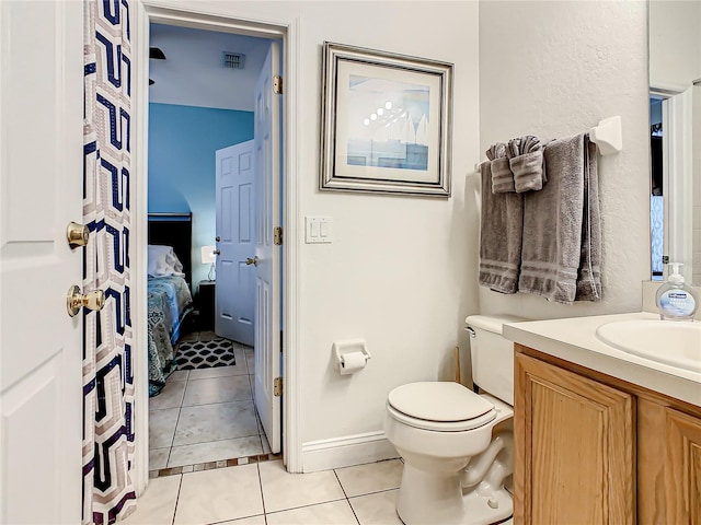 bathroom with toilet, tile floors, and vanity