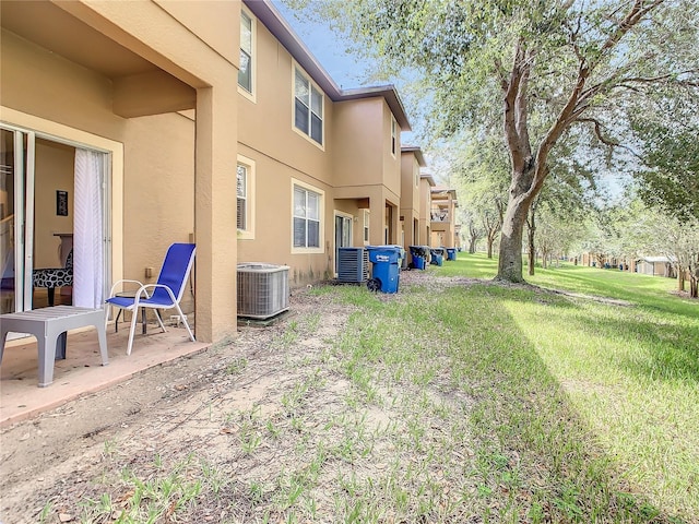 view of yard with a patio and central air condition unit