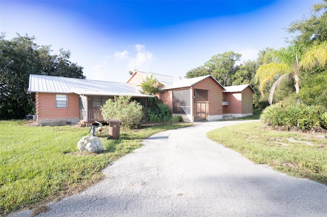 ranch-style home featuring central AC and a front lawn