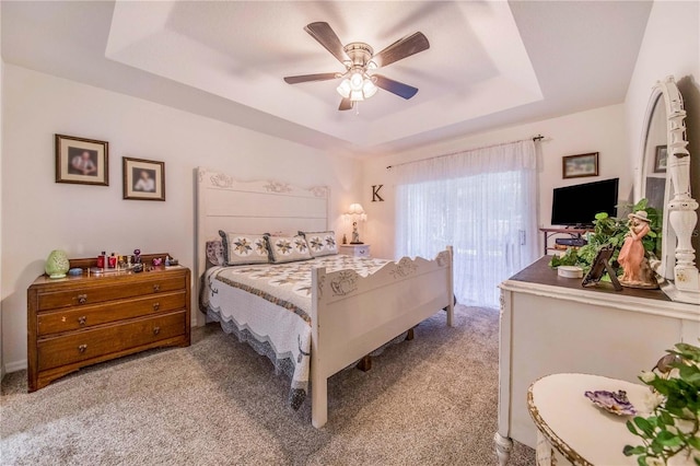 bedroom featuring light carpet, access to outside, ceiling fan, and a raised ceiling