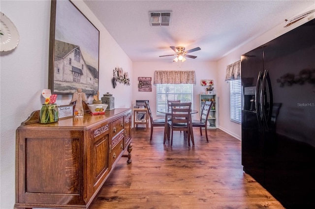 dining room with hardwood / wood-style floors and ceiling fan