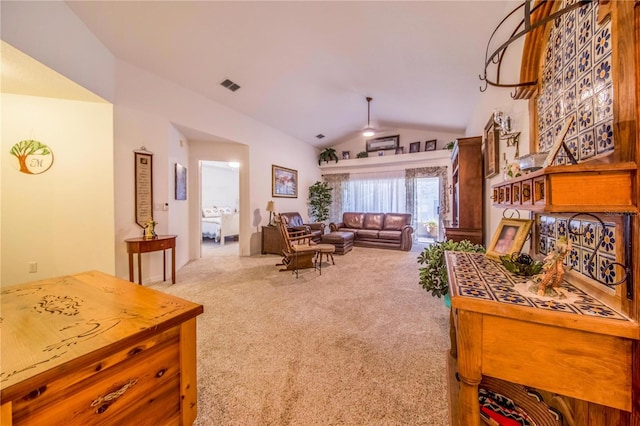 living room featuring carpet and vaulted ceiling