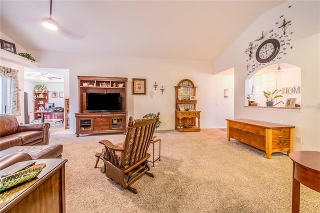 carpeted living room featuring ceiling fan and lofted ceiling