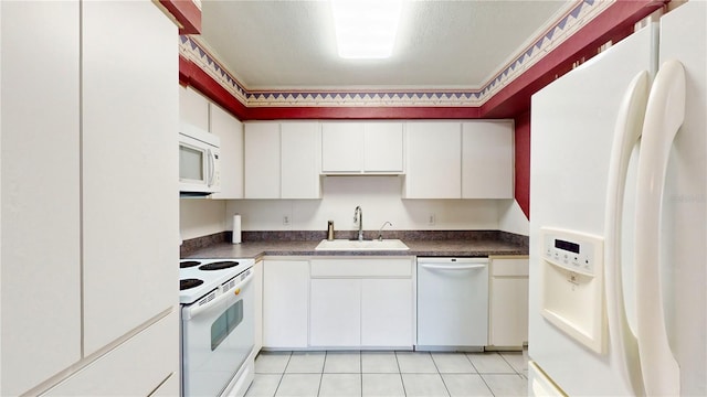 kitchen featuring sink, white appliances, white cabinets, and light tile patterned floors