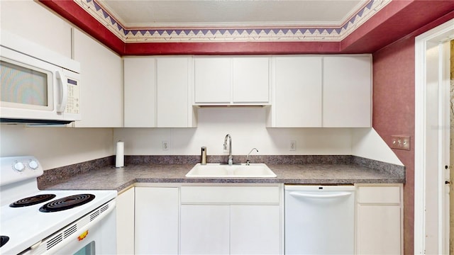 kitchen featuring white cabinetry, sink, and white appliances