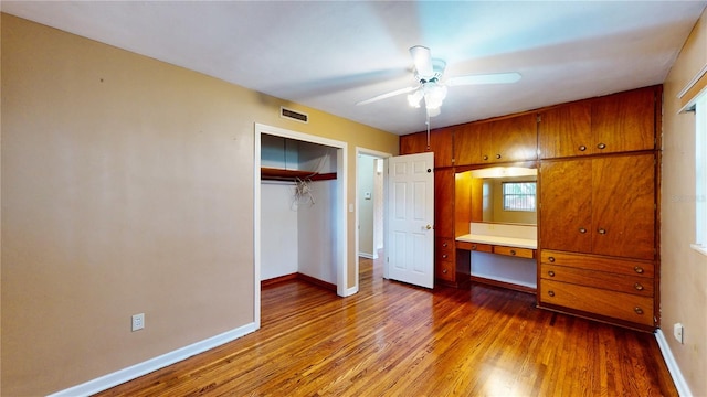 unfurnished bedroom featuring a closet, ceiling fan, and hardwood / wood-style floors