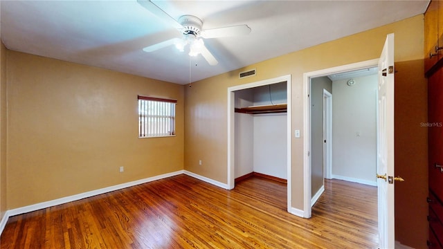 unfurnished bedroom featuring ceiling fan, a closet, and light hardwood / wood-style flooring