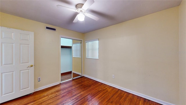 unfurnished bedroom with ceiling fan, a closet, and hardwood / wood-style floors