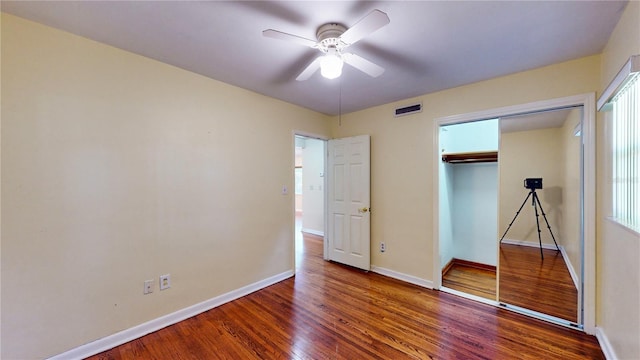 unfurnished bedroom featuring ceiling fan, a closet, and wood-type flooring