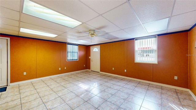 tiled spare room featuring ceiling fan and a paneled ceiling