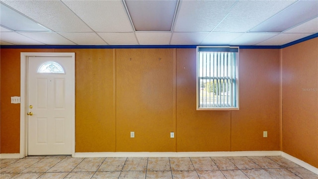 tiled foyer with a drop ceiling