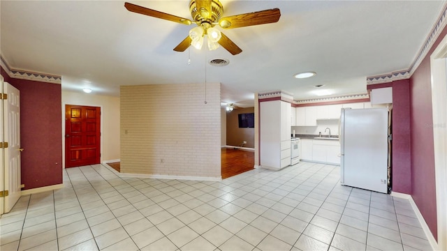 kitchen featuring sink, white appliances, ceiling fan, and light tile patterned floors