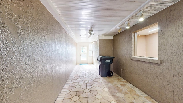 corridor featuring tile patterned flooring and track lighting