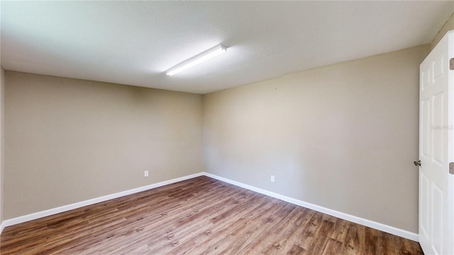 spare room with hardwood / wood-style floors