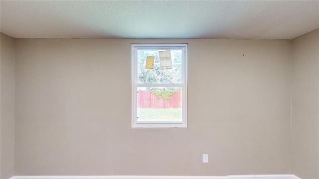 spare room featuring a textured ceiling