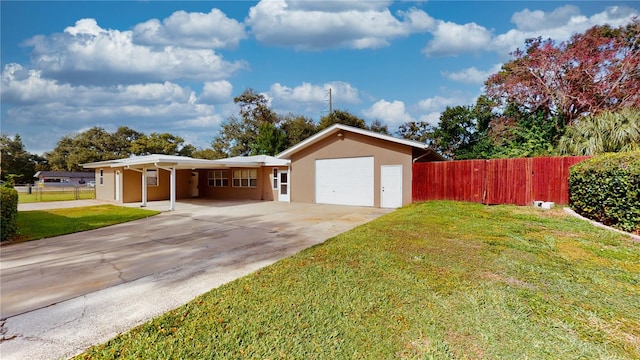 ranch-style home with a carport, a garage, and a front yard