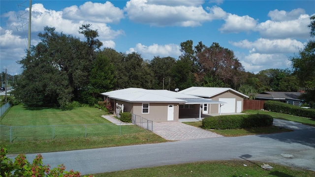 ranch-style home with a garage and a front lawn