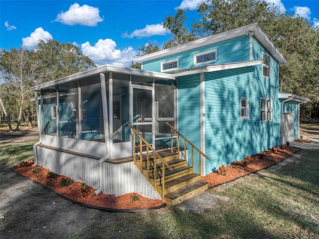 view of side of property featuring a sunroom