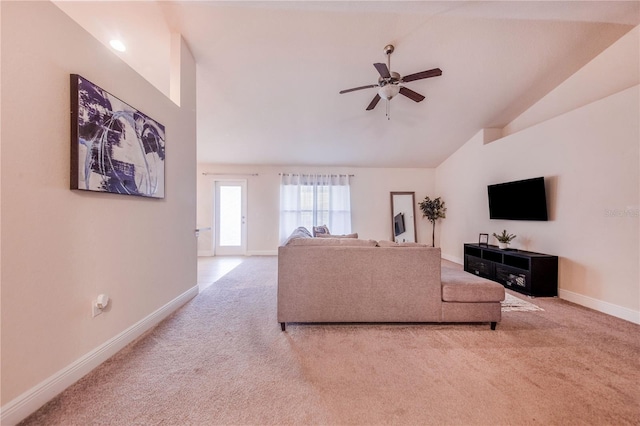 living room featuring ceiling fan, light carpet, and lofted ceiling