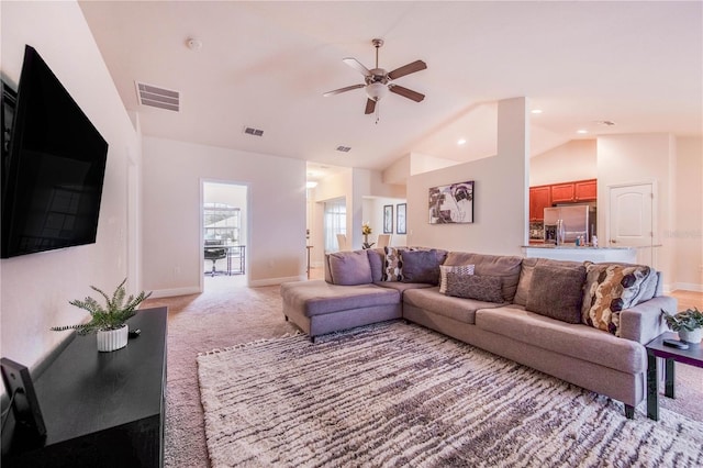 carpeted living room featuring ceiling fan and vaulted ceiling