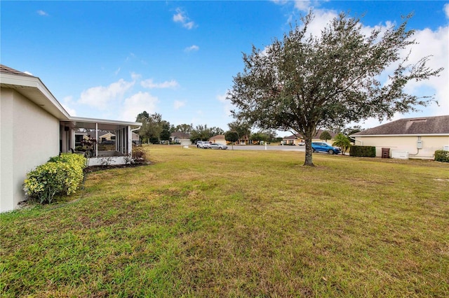 view of yard featuring a sunroom
