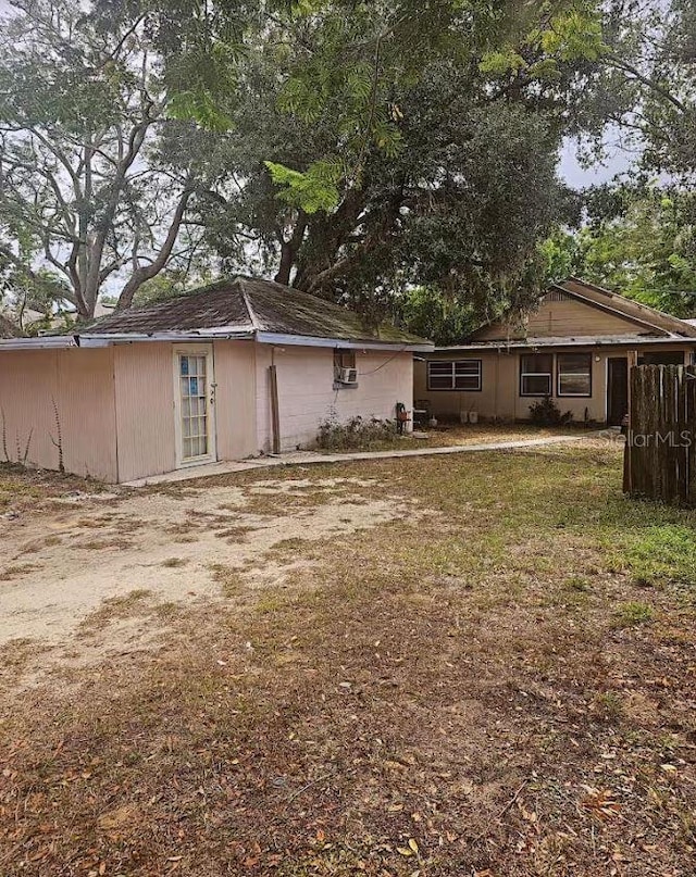 1414 Johns Ave, Haines City, FL 33844 - rear view of house with a yard