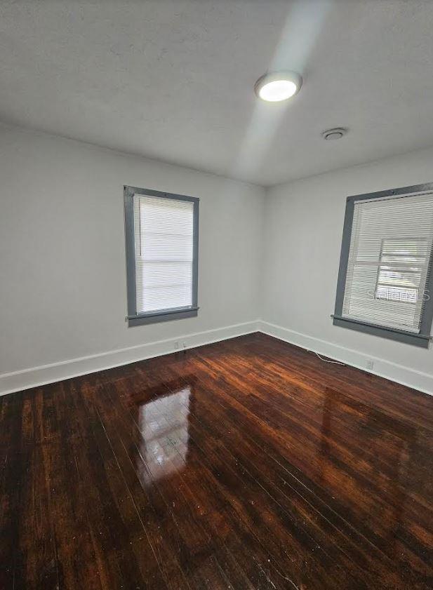 1414 Johns Ave, Haines City, FL 33844 - spare room featuring dark wood-type flooring