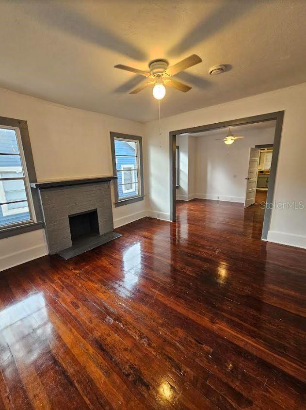 1414 Johns Ave, Haines City, FL 33844 - unfurnished living room with ceiling fan and dark wood-type flooring