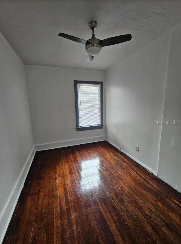 1414 Johns Ave, Haines City, FL 33844 - unfurnished room featuring dark hardwood / wood-style floors and ceiling fan