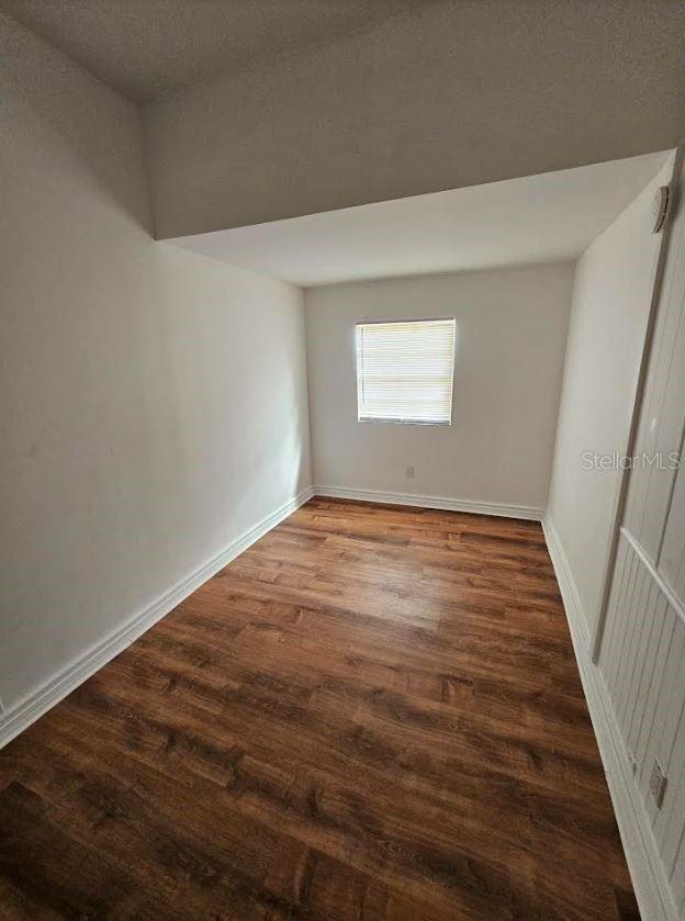 1414 Johns Ave, Haines City, FL 33844 - unfurnished room with a textured ceiling and dark hardwood / wood-style floors