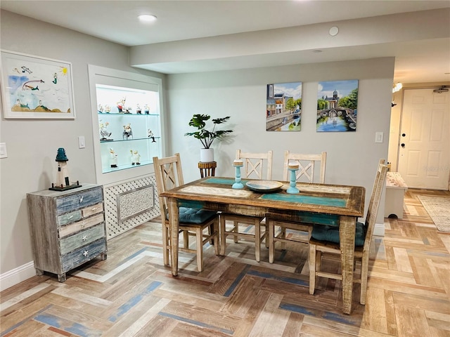 dining room featuring parquet floors