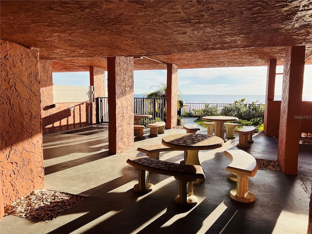 view of patio with a water view