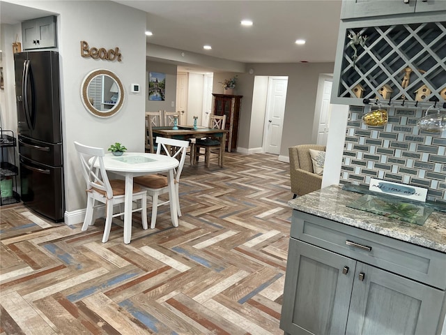 dining area with bar and light parquet floors