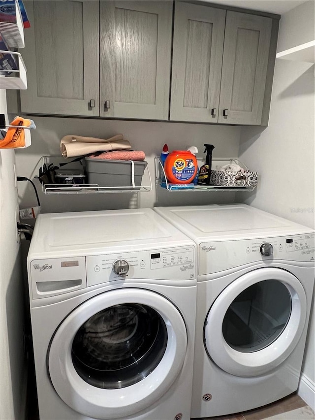 laundry area featuring cabinets and washing machine and clothes dryer