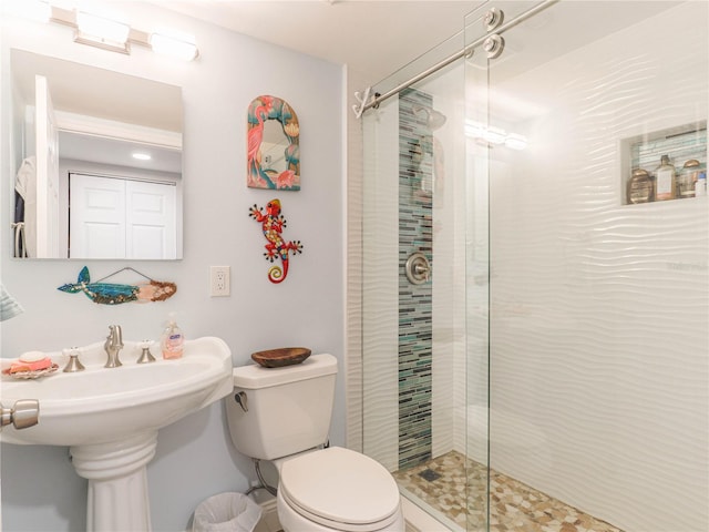 bathroom with toilet and a shower with door