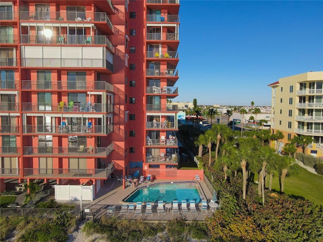 view of building exterior with a community pool