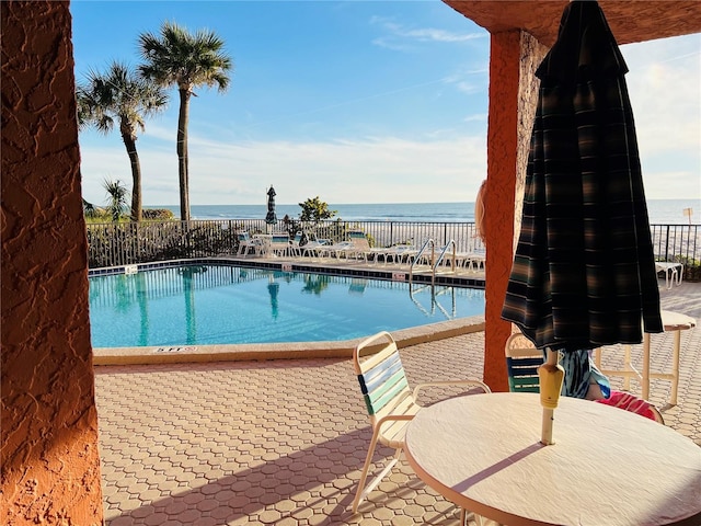 view of swimming pool featuring a water view