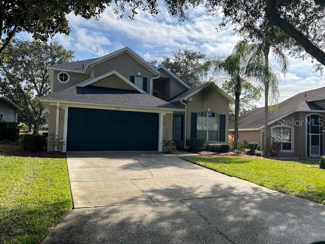 view of front of home with a garage and a front yard