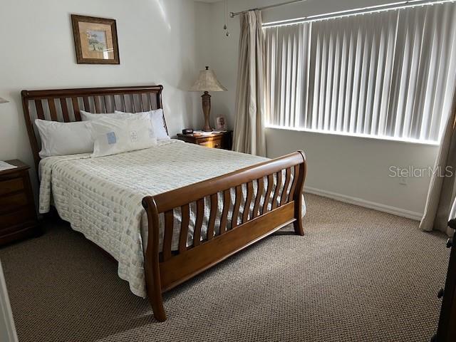 carpeted bedroom featuring baseboards