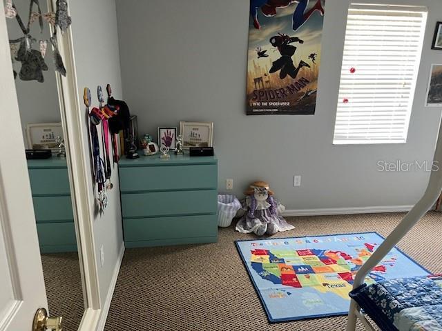 playroom with baseboards and carpet