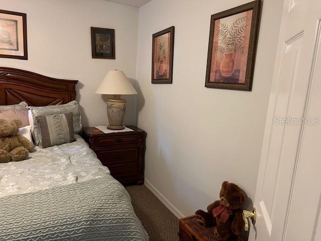 bedroom featuring baseboards and carpet floors